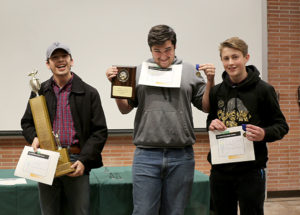Photo (left to right): Alan Cano, Cordell Doss, and Keyen Nusser of the winning Vilas A team show off their winnings at the November 2 LCC Knowledge Bowl.